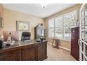 Bright home office featuring a large window with plantation shutters, a spacious desk, and ample storage at 1844 S Jay Way, Lakewood, CO 80232