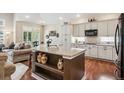 Open concept kitchen features granite countertops, a kitchen island, and seamless flow into the living space at 1844 S Jay Way, Lakewood, CO 80232