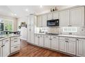 Bright kitchen with white cabinets, granite countertops, and stainless steel appliances, offering modern convenience at 1844 S Jay Way, Lakewood, CO 80232