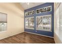 A sun-lit bedroom with wood floors and multiple windows for ample natural light at 4084 S Carson St # A, Aurora, CO 80014