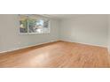 Bright bedroom with hardwood floors and a large window overlooking the neighborhood at 8304 Eaton Way, Arvada, CO 80003