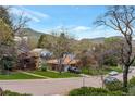 Street view of a well-maintained neighborhood with mature trees, landscaping, and mountain views at 2015 Arapahoe St, Golden, CO 80401