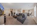 Spacious living room with L-shaped sectional sofa and large TV at 6005 Turnstone Pl, Castle Rock, CO 80104