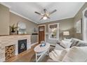 Cozy living room with decorative fireplace, hardwood floors, and a comfortable gray couch at 2731 S Logan St, Englewood, CO 80113