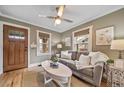 Comfortable living room with a gray couch, hardwood floors, natural light, and neutral paint colors at 2731 S Logan St, Englewood, CO 80113