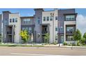 Stylish townhome with a modern facade, multiple windows, and well-maintained landscaping at 1575 W 68Th Ave, Denver, CO 80221