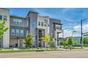Contemporary townhome exterior showcasing balconies, ample windows, and fresh green landscaping at 1575 W 68Th Ave, Denver, CO 80221