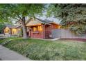 Lovely brick home with a well-maintained lawn and side access to the backyard at 1866 S Pennsylvania St, Denver, CO 80210