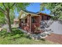 Classic brick home featuring lush greenery and a side entrance for added convenience at 1866 S Pennsylvania St, Denver, CO 80210