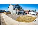 Charming two-story home with a well-manicured front yard, a covered front porch and two car garage at 397 Maple St, Bennett, CO 80102