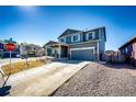 Charming two-story home with a well-manicured front yard, a covered front porch and two car garage at 397 Maple St, Bennett, CO 80102