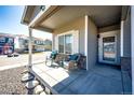 Inviting front porch featuring comfortable seating, perfect for relaxing and enjoying the neighborhood views at 397 Maple St, Bennett, CO 80102