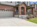 Close up showing the garage, entry, and landscaping of a charming two-story home at 25466 E 4Th Pl, Aurora, CO 80018