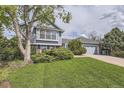 Well maintained home with lush front lawn, mature shade tree, and attached two car garage at 1758 S Ensenada St, Aurora, CO 80017