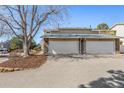 Exterior shot of two-car garages with stone accents and large driveways at 2650 S Vaughn Way # D, Aurora, CO 80014