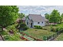 Charming home exterior surrounded by lush greenery and a well-maintained lawn at 2809 Yates St, Denver, CO 80212