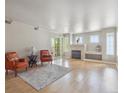 Bright living room with a cozy fireplace and sliding glass door to the balcony at 12348 W Dorado Pl # 204, Littleton, CO 80127