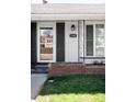Close up of the front door showing the house number with a brick planter at 1380 Roslyn St, Denver, CO 80220