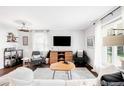 Bright living room with hardwood floors, modern furnishings, and ample natural light at 1380 Roslyn St, Denver, CO 80220