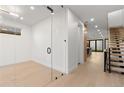 Modern living room showcasing hardwood floors, a glass partition wall, staircase and an open layout at 4225 N Navajo St, Denver, CO 80211