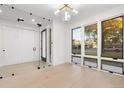 Bright living room featuring hardwood floors, large windows, and a modern light fixture creating an open space at 4225 N Navajo St, Denver, CO 80211