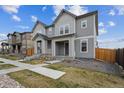 Pleasant view of two-story home in a suburban neighborhood featuring well-manicured front lawns and inviting walkways at 608 N Bersshine Ct, Watkins, CO 80137