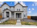Charming two-story home featuring a welcoming front porch and a well-maintained lawn in a suburban neighborhood at 608 N Bersshine Ct, Watkins, CO 80137