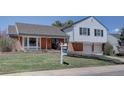 Beautiful home with a green lawn, brick facade, and a 'For Sale' sign in the yard at 5759 E Geddes Cir, Centennial, CO 80112