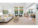 Bright and airy living room with vaulted ceilings, neutral decor, and view to dining room at 4674 Winona Pl, Broomfield, CO 80020
