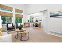 Open-concept living space featuring large windows, natural light, and view to dining room at 4674 Winona Pl, Broomfield, CO 80020