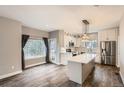 Modern kitchen with island, white cabinets, and stainless steel appliances at 19249 E Carolina Dr # 106, Aurora, CO 80017