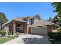 Beautiful home with brick and gray siding, a tile roof, and mature landscaping, perfect for curb appeal at 6500 W Mansfield Ave # 39, Denver, CO 80235