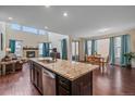 Bright, open kitchen with stainless steel appliances, granite countertops, and an eat-in dining area at 6335 E 143Rd Dr, Thornton, CO 80602