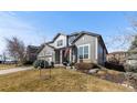 Charming two-story home with a well-manicured lawn and attached two-car garage at 9925 Keenan St, Highlands Ranch, CO 80130