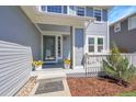 Welcoming covered front porch with decorative plants and seating area at 19075 E Grand Cir, Aurora, CO 80015