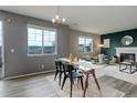 Bright dining area featuring modern table, chairs, and large windows with scenic views at 5546 Echo Hollow St, Castle Rock, CO 80104