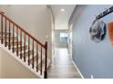 Bright hallway with hardwood floors, stairway, and stylish decor at 5546 Echo Hollow St, Castle Rock, CO 80104