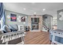 Cozy living room with a stone fireplace and modern decor at 9240 W Ontario Dr, Littleton, CO 80128