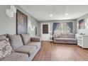 Spacious living room with wood floors, two couches and bright natural light at 9240 W Ontario Dr, Littleton, CO 80128