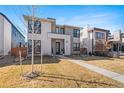 Charming two-story home with a well-lit walkway and stone accents on the front facade, offering curb appeal at 2255 S Monroe St, Denver, CO 80210