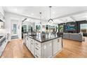 Bright, spacious kitchen with modern island, pendant lights, and stainless steel appliances at 2255 S Monroe St, Denver, CO 80210