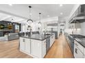 Modern kitchen with a large island, stainless steel appliances, and an open layout to the living area at 2255 S Monroe St, Denver, CO 80210