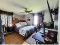 Cozy bedroom with wood floors and a comfortable bed at 985 Xavier St, Denver, CO 80204