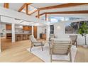 Bright living room featuring wooden beams, hardwood floors, and view to the kitchen at 456 Cherry Street, Denver, CO 80220