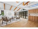 Bright living room featuring wooden beams and hardwood floors plus a large glass doors for outdoor view at 456 Cherry Street, Denver, CO 80220