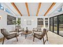 Living room with four chairs and a round table, complemented by hardwood floors and natural light at 456 Cherry Street, Denver, CO 80220