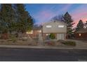 Two-story home featuring brick and vinyl siding, mature trees, and a well-maintained front yard at 10826 Livingston Dr, Northglenn, CO 80234