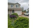 Attractive townhouse with landscaped front yard and convenient parking space at 11821 W Independence Ave, Lakewood, CO 80401