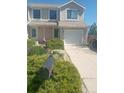 Inviting townhouse featuring a well-kept lawn and a convenient front entrance at 11821 W Independence Ave, Lakewood, CO 80401