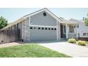 A cozy home with a two-car garage and well-maintained front lawn in a suburban setting at 18656 E Harvard Dr, Aurora, CO 80013